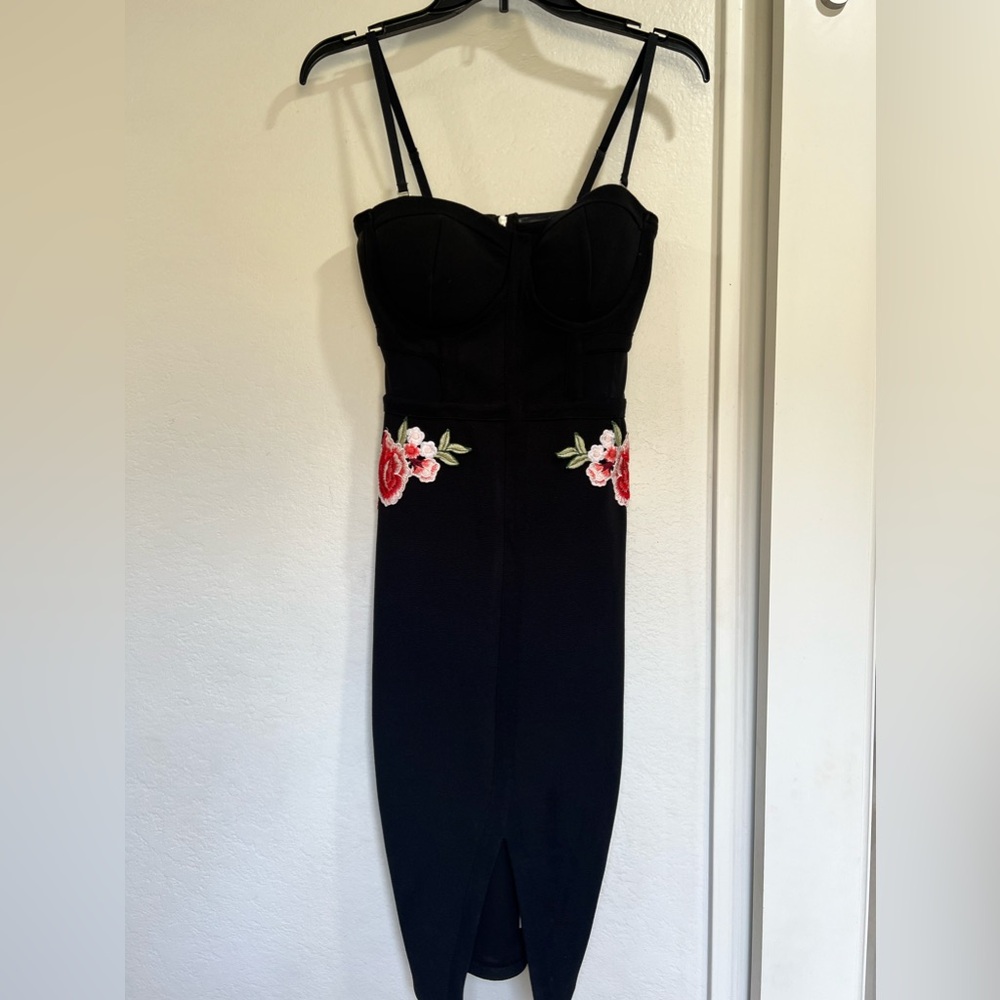 Black fitted dress with floral appliqué